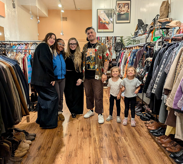 4 adults and 2 kids in clothing store