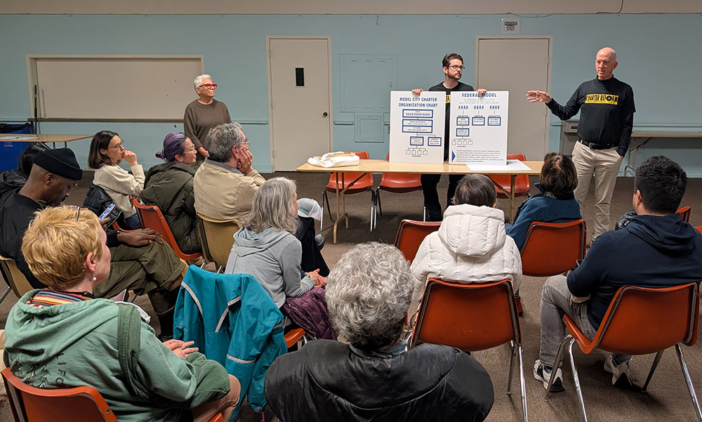 3 people speaking before a group
