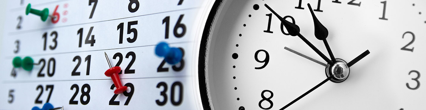 Time management concept. clock and calendar with marked dates.