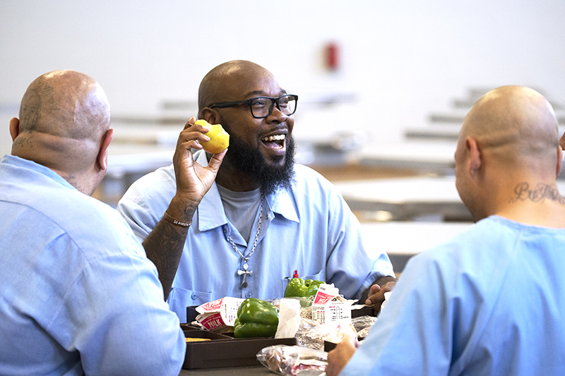 Three men in prison with food
