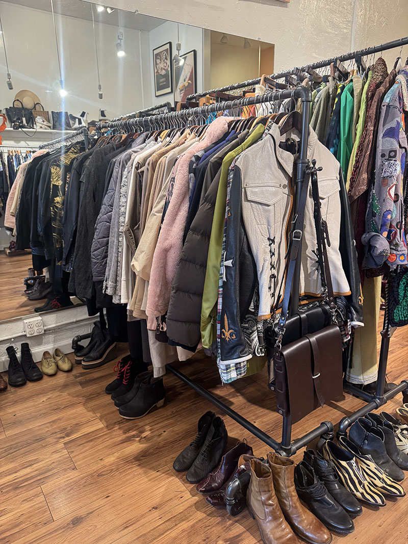 jackets on a rack, shoes underneath